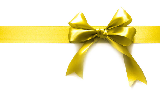 Gold ribbon with a bow as a gift on a white background - Photo, Image