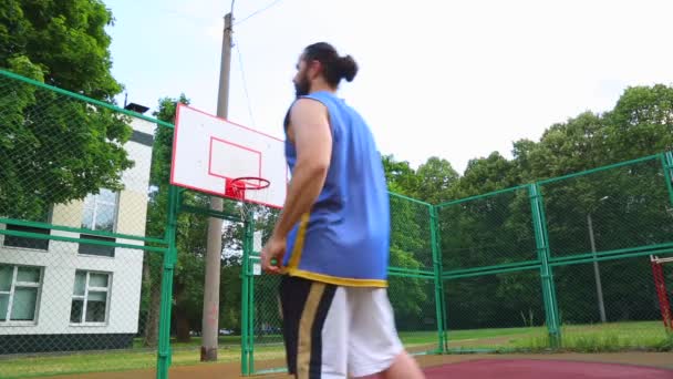 Basketball player trains on the street to score the ball in the basket. Training game of basketball. Concept sport, motivation, goal achievement, healthy lifestyle. - Footage, Video