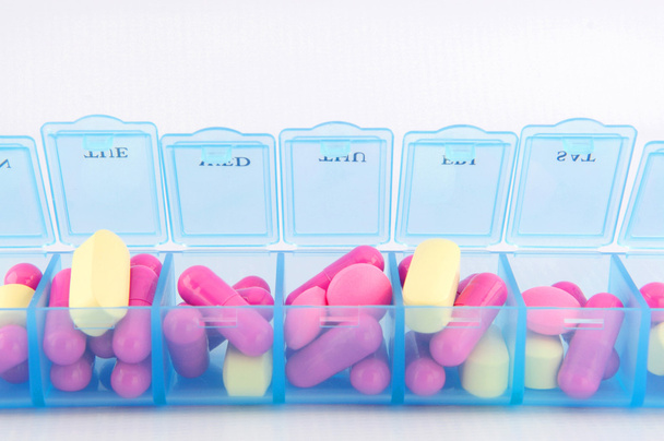 Closed up capsule and tablets in daily pill box - Photo, Image