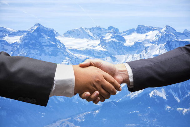 biznesmeni drżenie rąk na Snow Mountain w Szwajcarii ekspresyjne - Zdjęcie, obraz