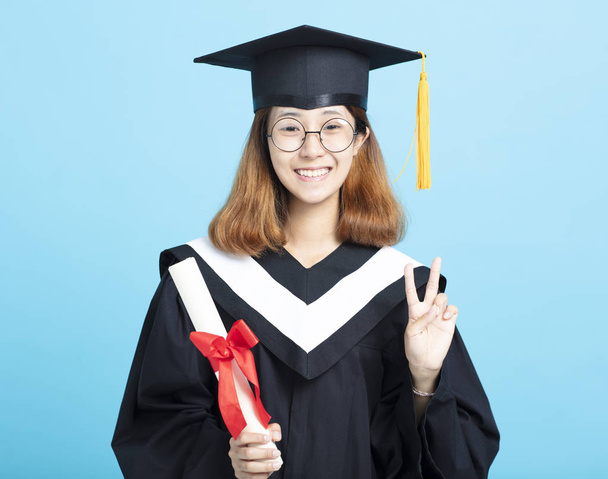 happy success graduation girl with victory gesture - Foto, afbeelding