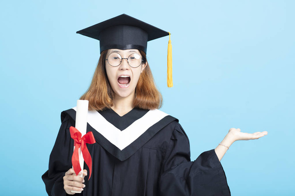 happy and excited  graduation girl  showing something on hand - Фото, изображение