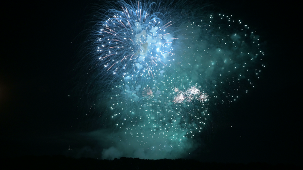 Dazzling large-scale fireworks with bright lights above the horizon. Live camera - Footage, Video