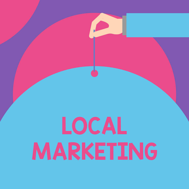 Handwriting text Local Marketing. Concept meaning A local business where a product buy and sell in area base Male hand arm needle punching big half blank balloon geometrical background. - Photo, Image