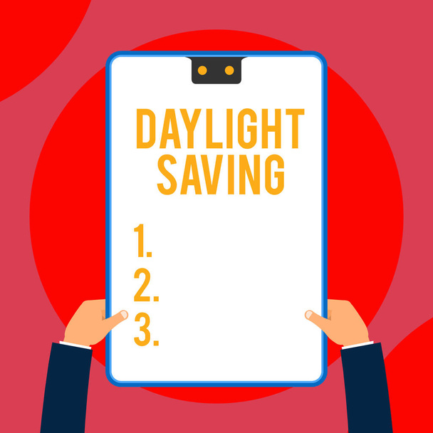 Text sign showing Daylight Saving. Conceptual photo Storage technologies that can be used to protect data Two executive male hands holding electronic device geometrical background. - Fotografie, Obrázek