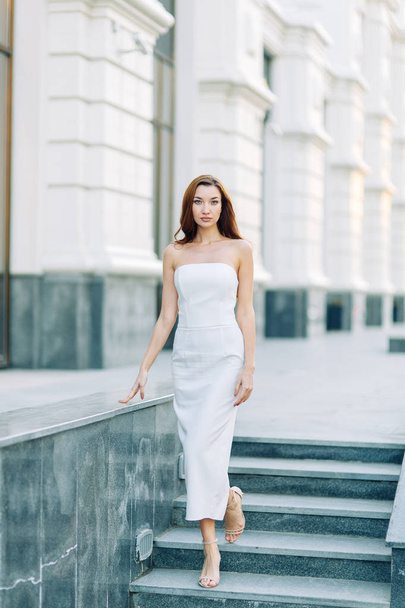 Summer look and white dress. Portraits of an elegant girl with luxury apartments. - Foto, imagen
