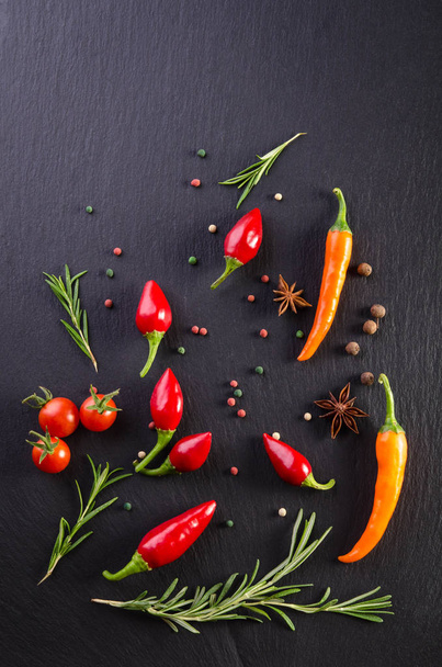 Different spices with tomato and  peppers on a black background - Fotografie, Obrázek