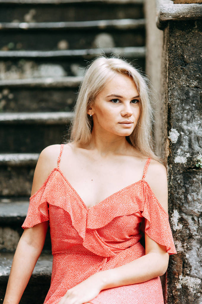  A beautiful girl in a red dress. Photo shoot on the evening streets of Kotor. - 写真・画像