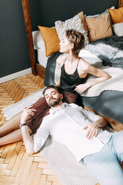 sensual photo shoot on the bed. Stylish young couple in the interior Studio.  - Valokuva, kuva