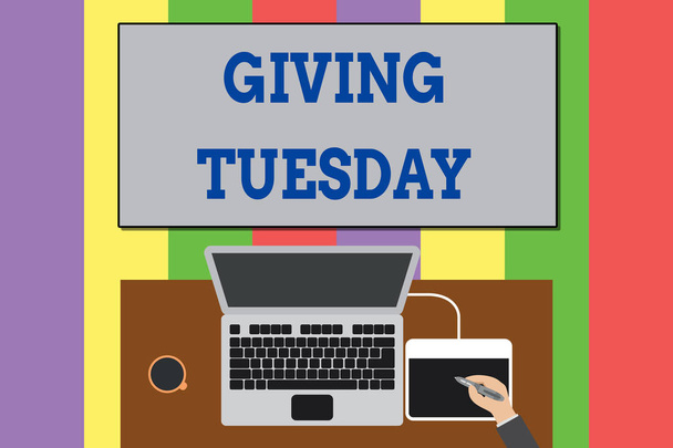 Text sign showing Giving Tuesday. Conceptual photo international day of charitable giving Hashtag activism Upper view laptop wooden desk worker drawing tablet coffee cup office. - Fotografie, Obrázek