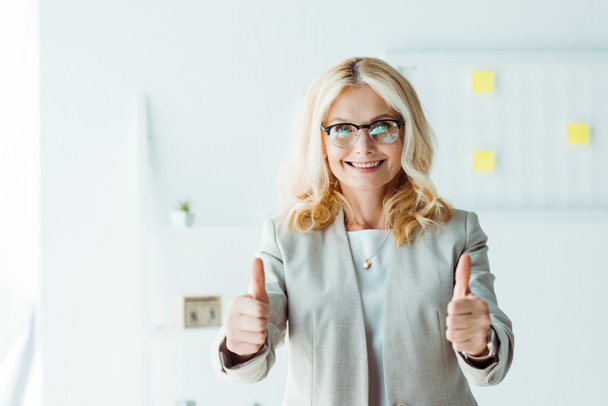 cheerful recruiter in glasses showing thumbs up in office  - Photo, Image