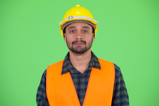 Rosto do jovem homem barbudo persa trabalhador da construção
 - Foto, Imagem