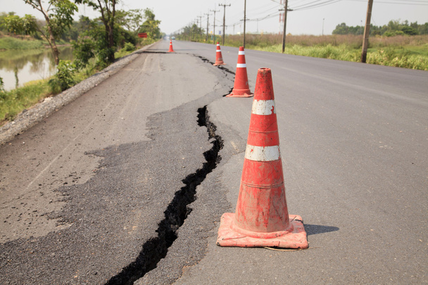 Traffic cones on the cracked asphalt road - Photo, Image
