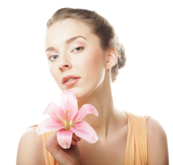 Beauty face of the young woman with pink lily - Φωτογραφία, εικόνα