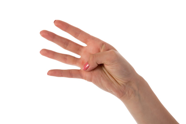Γυναικείο χέρι που δείχνει τέσσερα δάχτυλα απομονωμένα σε λευκό φόντο - Φωτογραφία, εικόνα