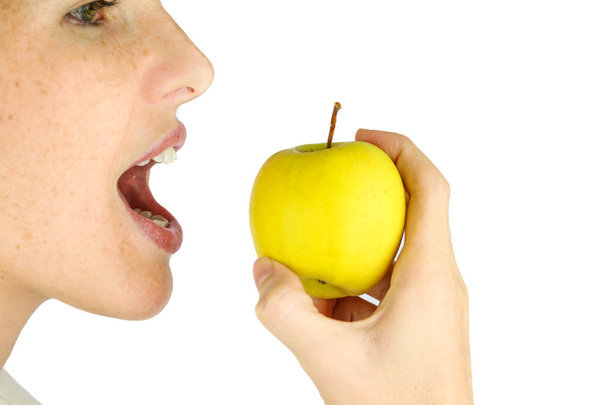 Girl taking a bite of an apple. - Fotografie, Obrázek