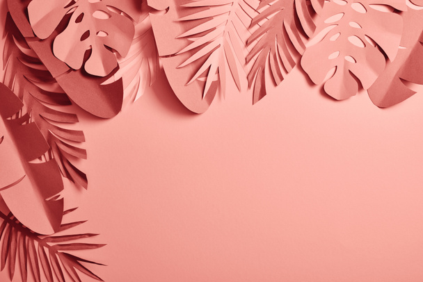 top view of exotic paper cut palm leaves on pink background with copy space - Zdjęcie, obraz