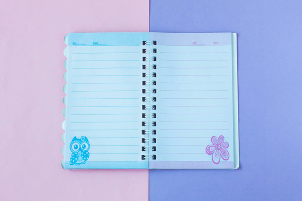 Notebook with lines. School stationery on a pink and purple duotone background. - Φωτογραφία, εικόνα