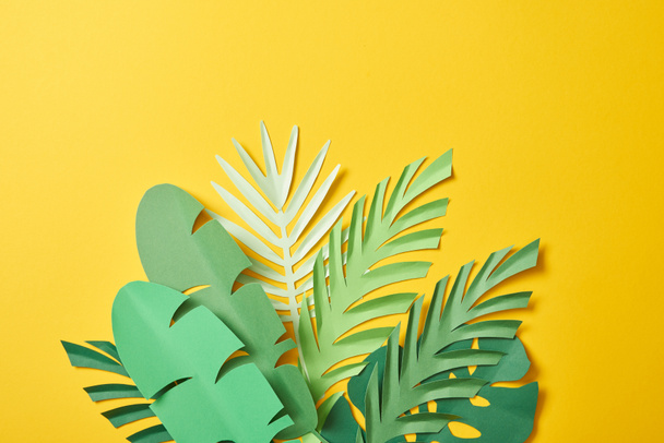 racimo de hojas de palma verde exóticas cortadas en papel sobre fondo amarillo con espacio para copiar
 - Foto, imagen