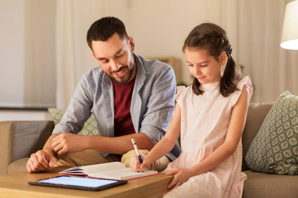 father and daughter doing homework together - 写真・画像