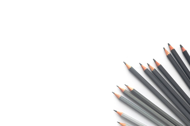 Many gray pencils on a white background. Top view - Foto, afbeelding