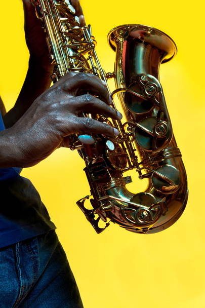 Young african-american jazz musician playing the saxophone - Photo, Image