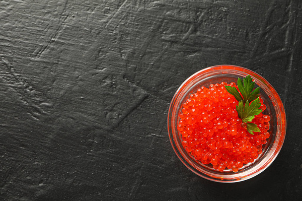 Glass jar with caviar on black background, space for text - Photo, Image