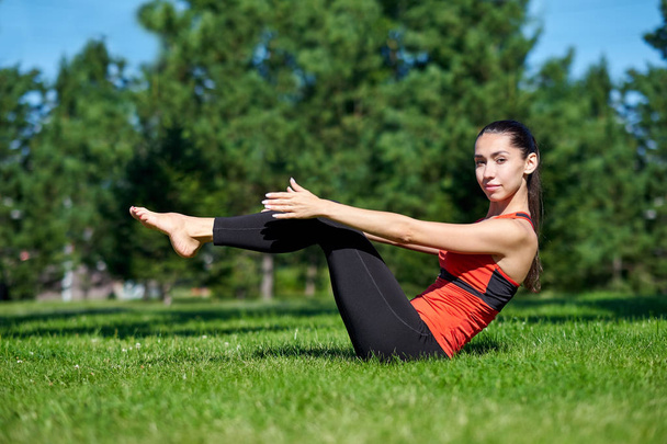 Yoga. Young woman practicing yoga meditation in nature at the park. Health lifestyle concept - Φωτογραφία, εικόνα