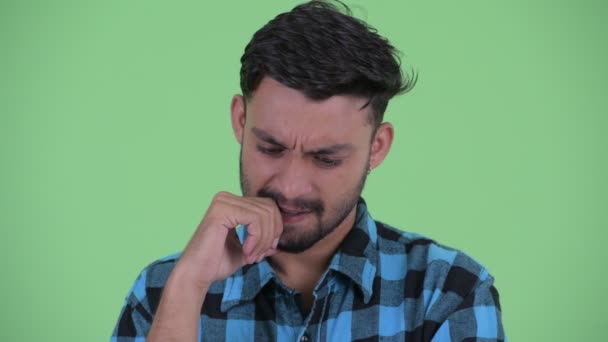 Face of stressed young bearded Persian hipster man thinking - Záběry, video