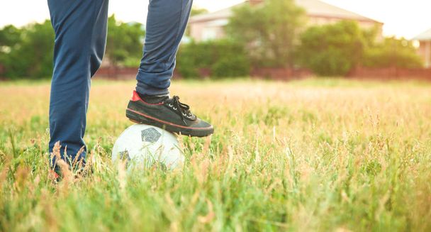 Garoto caucasiano com uma bola de futebol em um campo de futebol. - Foto, Imagem