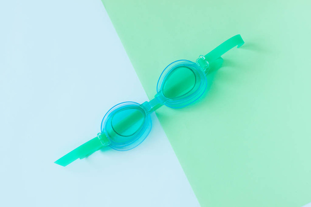 Summer flatlay with watersport goggles, mint and light blue background, minimalistic style, copy space. - Photo, image