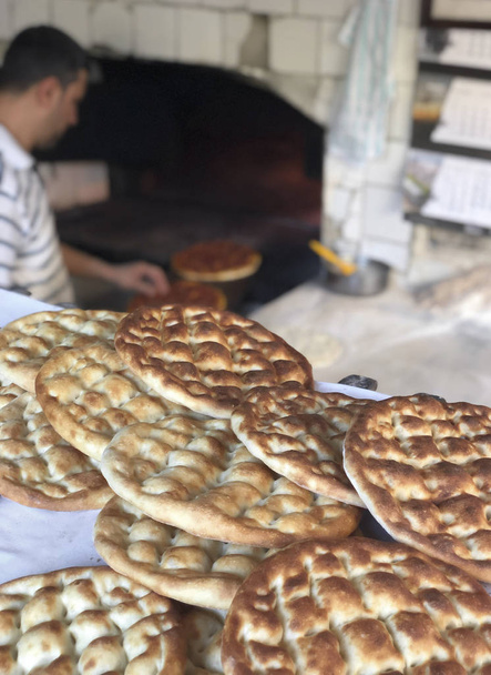 A baker preparing Turkish pita bread for ramadan - Photo, Image