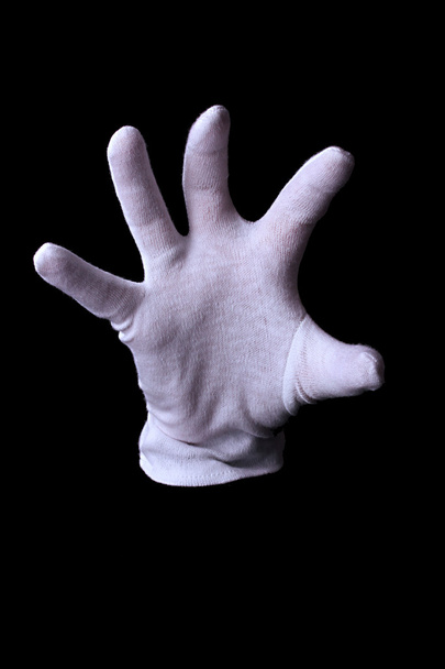 Hand in white glove making sign isolated on black - Fotografie, Obrázek