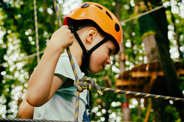 the boy climbs the rope park - Фото, изображение