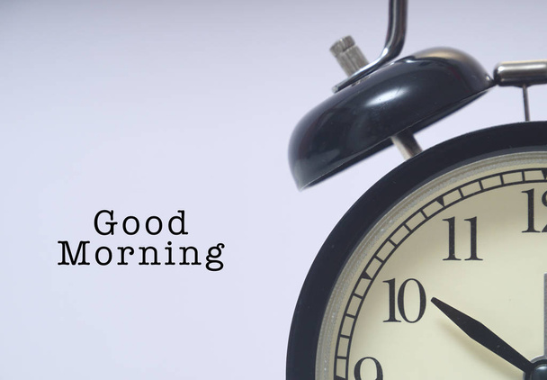 Words written GOOD MORNING next to alarm clock - Foto, imagen