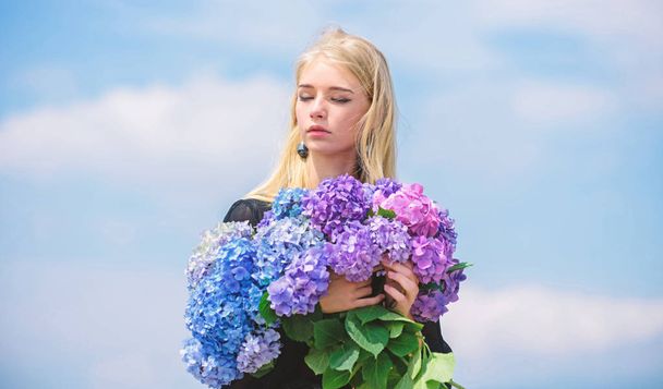 Stop allergy blooming season. Enjoy spring without allergy. Springtime bloom. Pollen allergy. Gentle flower for delicate woman. Girl tender blonde hold hydrangea flowers bouquet. Allergy free life - Фото, изображение