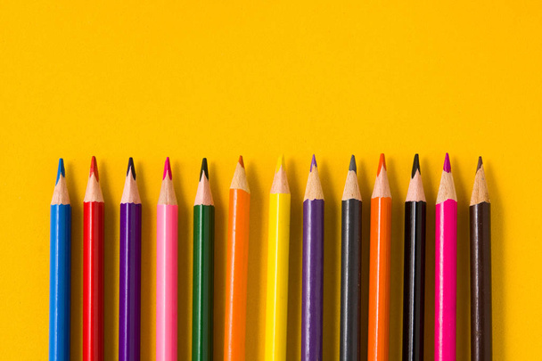 Color pencils on yellow background. Copyspace - Photo, Image