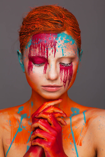 Portrait of a model in an expressive creative style using an unusual make-up - Fotó, kép