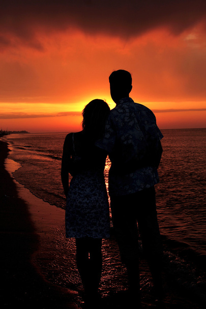 silhouette of a loving couple at sunset - Photo, Image