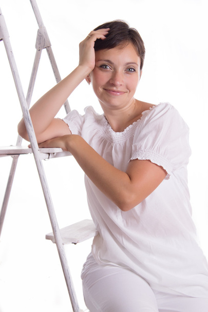 Smiling woman sitting on step ladder - Fotografie, Obrázek