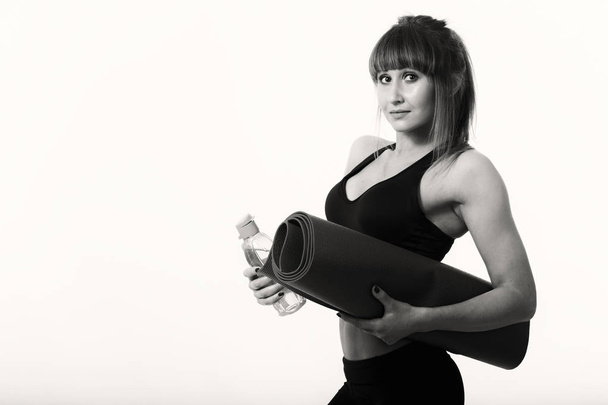 sporty girl with a yoga mat - Photo, Image