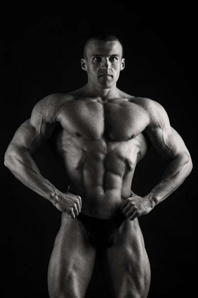 Bodybuilder showing his back and biceps muscles, personal fitnes - Fotó, kép