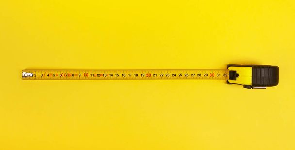 Yellow Measuring Tape on yellow background. - Photo, Image