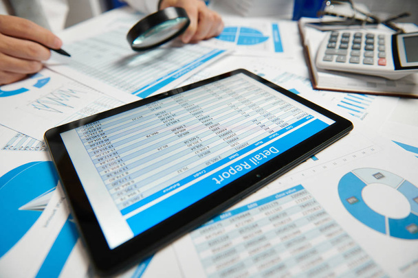 Businessman working and calculating, reads and writes reports. Using tablet pc. Office employee, table closeup. Business financial accounting concept. - Photo, Image