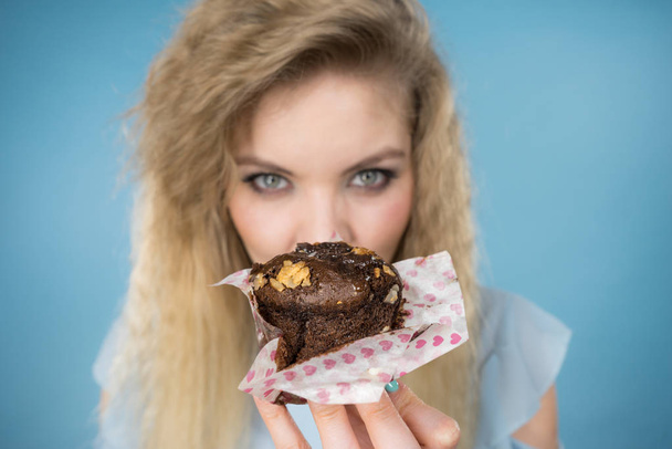 Attractive woman holds cake in hand - Photo, Image