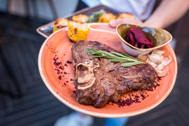 grilled sliced steak and rosemary on plate. serving dishes in the restaurant - Photo, Image