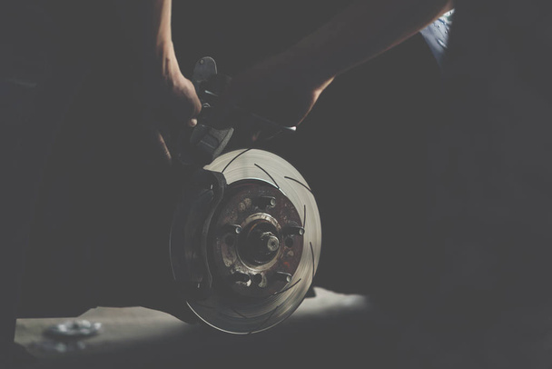 Travão de disco e almofadas de freio de amianto na garagem do carro
 - Foto, Imagem