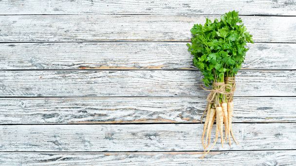 Parsley root on a white wooden background. Top view. Free space for your text. - Valokuva, kuva