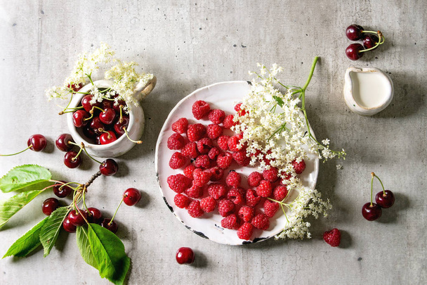 Fresh cherry and raspberry berries - 写真・画像