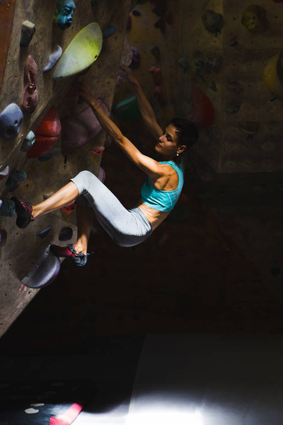 A woman is training in a climbing gym. - 写真・画像
